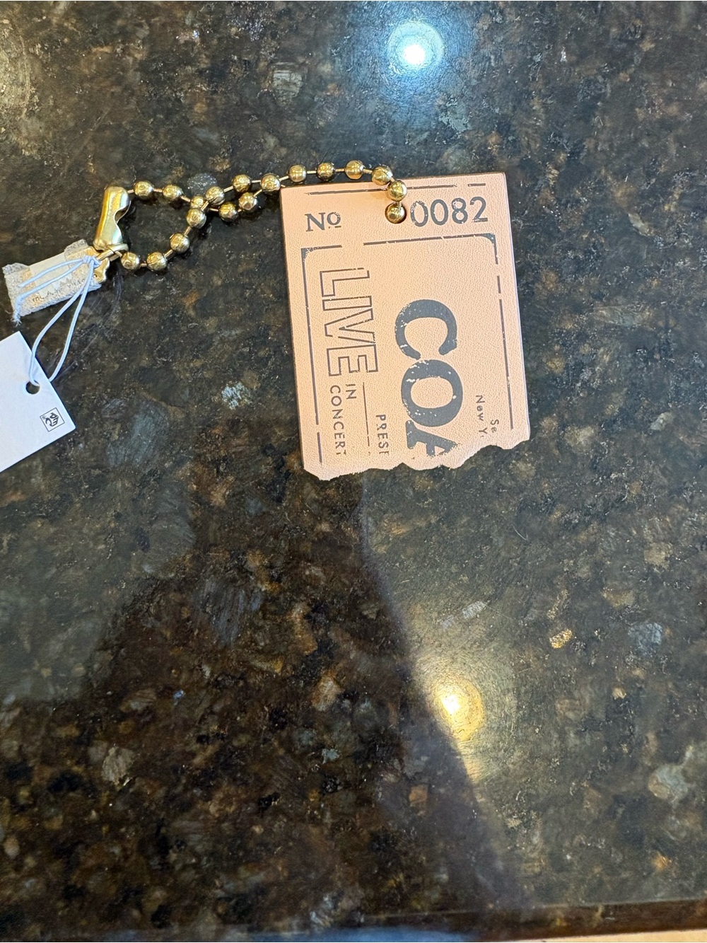 Coach ticket bag charm